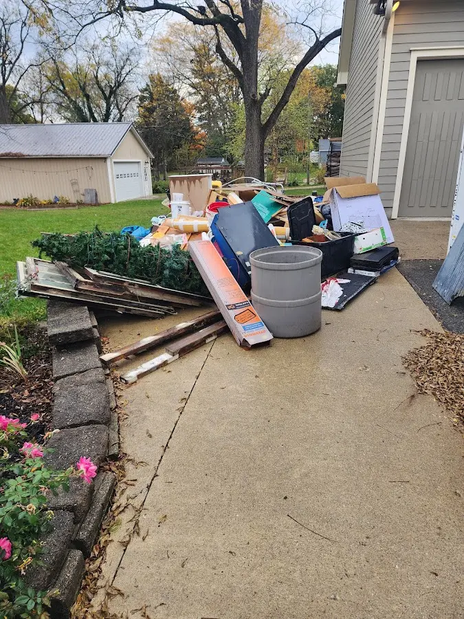 Dumpster being loaded with debris for Estate Cleanout Dumpster Rental in Chandler